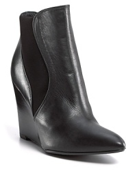 It's all about architecture. Curvaceous wedge heels, sleek pointed toes and stretch side panels combine for a stylishly sound bootie. By Stuart Weitzman. It's all about architecture. Curvaceous wedge heels, sleek pointed toes and stretch side panels combine for a stylishly sound bootie. By Stuart Weitzman.