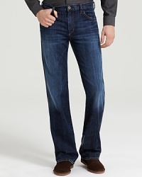 Low-waist, five-pocket bootcut jeans with zip fly. Deep blue wash with no fading, no distress. Features whiskering at the crotch and back of knee. Low-waist, five-pocket bootcut jeans with zip fly. Deep blue wash with no fading, no distress. Features whiskering at the crotch and back of knee.