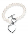 Cultured freshwater pearls (7-8 mm) get a modern update with a chic toggle clasp and polished heart charm in sterling silver. Approximate length: 7-1/2 inches. Approximate charm drop: 1 inch.