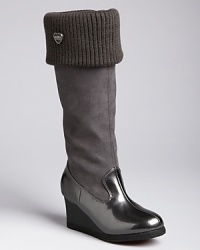 A cozy rib knit trims the opening of KORS Michael Kors' Pavia boots, a tall style equipped with a wedge heel. A cozy rib knit trims the opening of KORS Michael Kors' Pavia boots, a tall style equipped with a wedge heel.