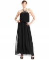 Vince Camuto's halter gown gleams with a shimmering paillette embellishment at the neckline and an effortlessly sophisticated silhouette.  A pleated blouson-style bodice balances structure with a breezy fit.