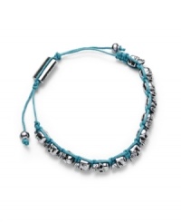 Edgy, with a feminine undertone. Ali Khan's silver-plated mixed metal bracelet features several tiny skulls along a turquoise-colored cord. Bracelet is fully adjustable. Approximate length: 12 inches. Approximate diameter: 2 inches. Edgy, with a feminine undertone. Ali Khan's silver-plated mixed metal bracelet features several tiny skulls along a turquoise-colored cord. Bracelet is fully adjustable. Approximate length: 12 inches. Approximate diameter: 2 inches.
