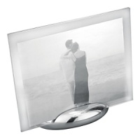 Accommodating either a vertical or horizontal photo, this rectangular photo frame consists of an oval base made of Nambé alloy and two sheets of glass to enclose a photo. The Nambé alloy base is solid and stable. Designed by Neil Cohen. Accommodating either a vertical or horizontal photo, this rectangular photo frame consists of an oval base made of Nambé alloy and two sheets of glass to enclose a photo. The Nambé alloy base is solid and stable. Designed by Neil Cohen.