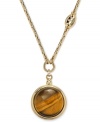 Eye of the tiger. This exotic pendant necklace from Fossil features a watch fob-inspired pendant with a round tiger's eye bead. Crafted in shiny gold tone mixed metal. Approximate length: 16 inches + 2-inch extender. Approximate drop: 1-1/2 inches.