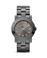 Substance meets MARC BY MARC JACOBS style on this plated metal watch which is illuminated by bright crystals, an engraved logo, and a smooth round dial. Substance meets MARC BY MARC JACOBS style on this plated metal watch which is illuminated by bright crystals, an engraved logo, and a smooth round dial.