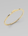 A slender golden bangle with a modern squared edge, shaped with a tab extension set with a sparkling diamond.Diamonds, .16 tcwBrassDiameter, about 3Imported