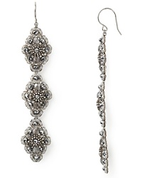 Dangling drop earrings from Miguel Ases blend textured beading with pearlescent luminance for dramatic earth goddess glamour. Dangling drop earrings from Miguel Ases blend textured beading with pearlescent luminance for dramatic earth goddess glamour.
