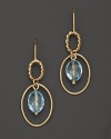 Faceted oval blue topaz adds rich sparkle to links of 14K yellow gold. By Nancy B.