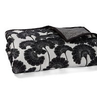 A stark black and white print, stitched around each flower, reverses to a fine stripe. A stark black and white print, stitched around each flower, reverses to a fine stripe.