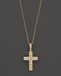 Petite diamond pavé-set cross pendant set in 14K yellow gold. Petite diamond pavé-set cross pendant set in 14K yellow gold.