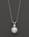 A cultured pearl pendant necklace on a chain.