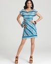 A retro-inspired zig-zag pattern enlivens this Julie Dillon dress, finished with a chic faux-wrap skirt.