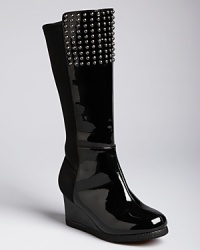 A girlie wedge with rockin' edge, this flashy patent leather boot features a dramatic wedge rise and studs at the top. A girlie wedge with rockin' edge, this flashy patent leather boot features a dramatic wedge rise and studs at the top.