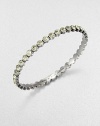 Lovely faceted glass stones with a radiant silvery tint are dotted along a slender bangle with a polished finish.GlassSilvertoneDiameter, about 2.5Imported