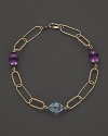 Faceted oval amethyst and blue topaz add rich sparkle to links of 14K yellow gold. By Nancy B.