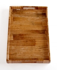 Fruits of their labor. This layered banana leaf tray, handcrafted by Haitian artisans, serves as a table for breakfast in bed, a space to corral magazines or cosmetics and simply a beautiful accent wherever you place it. With a glossy, shellacked finish. Fruits of their labor. This layered banana leaf tray, handcrafted by Haitian artisans, serves as a table for breakfast in bed, a space to corral magazines or cosmetics and simply a beautiful accent wherever you place it. With a glossy, shellacked finish.