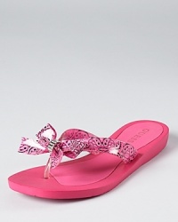 Go off-duty with GUESS--the Tutu bow flip flops offer playful, casual style. Go off-duty with GUESS--the Tutu bow flip flops offer playful, casual style.