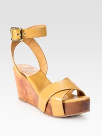 Held in place by a wide adjustable ankle strap, soft leather straps top an earthy wooden wedge and platform. Wooden wedge, 3 (75mm)Wooden platform, 1 (25mm)Compares to a 2 heel (50mm)Leather upperLeather liningRubber solePadded insoleImportedOUR FIT MODEL RECOMMENDS ordering true size. 