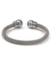 Majorica's steely gray bangle exudes cool confidence. Solo or stacked, wear yours at cocktail hour to give night time looks a strong spin.