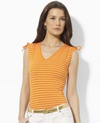 A classic sleeveless tee is updated with chic ruched detailing at the arms in this Lauren by Ralph Lauren look. A classic sleeveless tee is updated with chic ruched detailing at the arms in this Lauren by Ralph Lauren look.