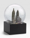 EXCLUSIVELY OURS. The New York City musical snow globe features city scenes and landmarks, including: Saks Fifth Avenue flagship store St. Patrick's Cathedral, Empire State Building Statue of Liberty, Chrysler Building, Brooklyn Bridge Plays New York, New York Glass dome with resin figures 6 high Imported