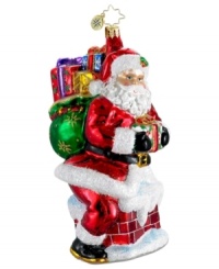 About to make his grand entrance, Santa Claus is the picture of merriment in this handcrafted glass ornament, featuring the dazzling brilliance of Christopher Radko.