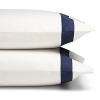 A classic navy sateen border trims these pillowcases by SFERRA, woven from super soft Egyptian cotton.