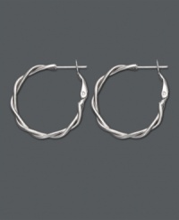A simple twist takes your look a long way. Traditional hoop earrings feature a twisted design in sterling silver. Approximate diameter: 7/8 inch.