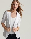 Lace brings romance to this smartly tailored GUESS blazer, finished with a single-button closure.