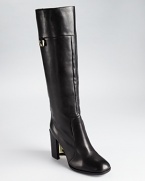 A cutout, concave heel shows off an optic effect with a holograph-like two tone effect. From DIANE von FURSTENBERG.