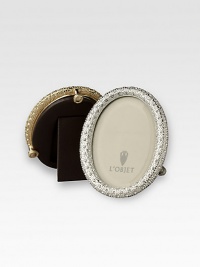 A keepsake accent for life's favorite moments and people, upholstered in smooth leather with gold- or platinum-plating and glimmering Swarovski crystals. Accommodates a 2 X 3 round photograph Hand wipe Imported A keepsake accent for life's favorite moments and people, upholstered in smooth leather with gold- or platinum-plating and glimmering Swarovski crystals. Accommodates a 2 X 3 round photograph Hand wipe Imported