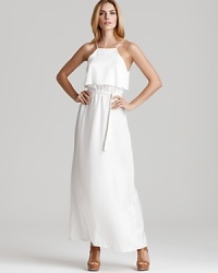 A white Kimberly Taylor maxi dress imbues your day with beachy sensibility, light and airy with a ruffle at top and a flowing skirt. Nude sandals complete the ethereal look with chic. A white Kimberly Taylor maxi dress imbues your day with beachy sensibility, light and airy with a ruffle at top and a flowing skirt. Nude sandals complete the ethereal look with chic.