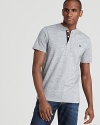 The signature Fred Perry logo accents the left chest of this reliable and handsome henley tee.