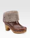 An ultra-soft shearling cuff tops this studded design of rich leather, lifted by a wooden heel. Wooden heel, 3 (75mm)Wooden platform, 1 (25mm)Compares to a 2 heel (50mm)Leather and shearling upperPull-on styleShearling liningRubber solePadded insoleImported