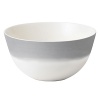 A watercolor wash of gradient gray migrates toward a warm neutral center to create an organic ombre effect on this durable, adaptable bowl from Vera Wang.
