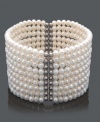 Layer your wrist in nine, elegant rows of pearl. This bracelet features cultured freshwater pearls (4-5 mm) in a chic cuff design. Crafted in sterling silver. Bracelet stretches to fit wrist. Approximate length: 7 inches.