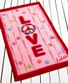 Far-out style. Retro peace signs and hearts in a red and pink colorway give this Lolita Peace and Love beach towel a playful feel perfect for a fun day at the beach!