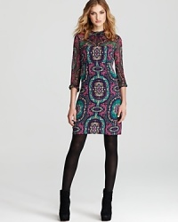 A paisley print in jewel tones brings enviable style to this Nanette Lepore dress with sheer, twisted neckline and sleeves. A paisley print in jewel tones brings enviable style to this Nanette Lepore dress with sheer, twisted neckline and sleeves.