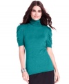 Style&co. ruched the sleeves of this fitted turtleneck sweater for a femme finishing touch.