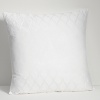 Embroidered and embellished decorative pillows complement the bedding ensemble.
