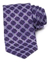 An optic floral print conforms into a grid-like pattern on a silk tie from Ike Behar.