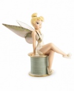 Disney's Tinkerbell sits primly atop a spool of thread in this vividly detailed porcelain figurine by Lenox. Accented with 24-karat gold.