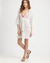 A gorgeous crochet coverup with a feminine self-tie neckline.Deep v-necklineThree-quarter sleevesSelf-tie frontCord endsElasticized waistCottonDry cleanMade in USA of imported fabric