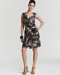 A graphic print emboldens this Julie Dillon dress, cut in a figure-flattering wrap silhouette complete with waist-cinching belt.