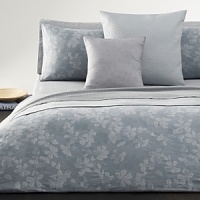 Woven matelassé sham coordinates with Calvin Klein Home Oval Bands Coverlet.