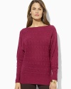 A unique horizontal cable knit and dolman sleeves lend modern appeal to a chic boatneck sweater.