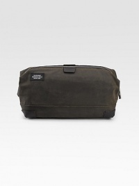 A vacation essential in lasting cotton canvas soaked in a paraffin formula designed for strength and abrasion resistance. Reinforced bridle leather corners and a waterproof lining ensure a long life for everywhere you go. Zip closure Wire frame mouth Interior zip pocket Waterproof lining 10W X 4H X 6D Imported A vacation essential in lasting cotton canvas soaked in a paraffin formula designed for strength and abrasion resistance. Reinforced bridle leather corners and a waterproof lining ensure a long life for everywhere you go. Zip closure Wire frame mouth Interior zip pocket Waterproof lining 10W X 4H X 6D Imported