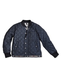 This woodsy quilted jacket features a touch of Burberry's signature check at the collar and lining. This woodsy quilted jacket features a touch of Burberry's signature check at the collar and lining.