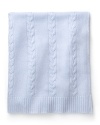 A soft blue cable cashmere blanket by Aqua, wraps baby in sumptuous warmth.