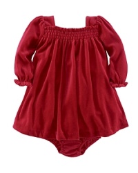 An adorable dress is crafted from plush velour for an ultra-soft feel, perfect for holiday festivities. An adorable dress is crafted from plush velour for an ultra-soft feel, perfect for holiday festivities.